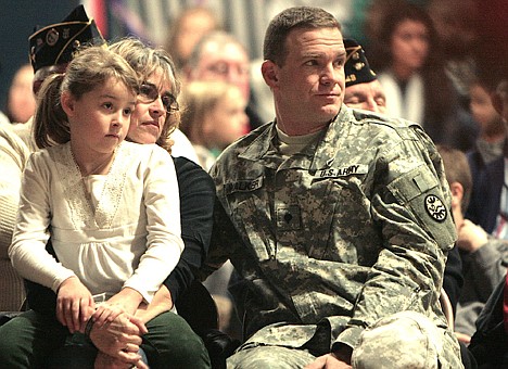 &lt;p&gt;Vivian Leonard, a Ponderosa Elementary first-grader, listens to Veterans Day speakers with her mother, Trish Leonard-Walker, and stepfather Chris Walker on Monday during a ceremony at the Post Falls school. Both Trish and Chris served in Iraq with the Idaho Army National Guard.&lt;/p&gt;