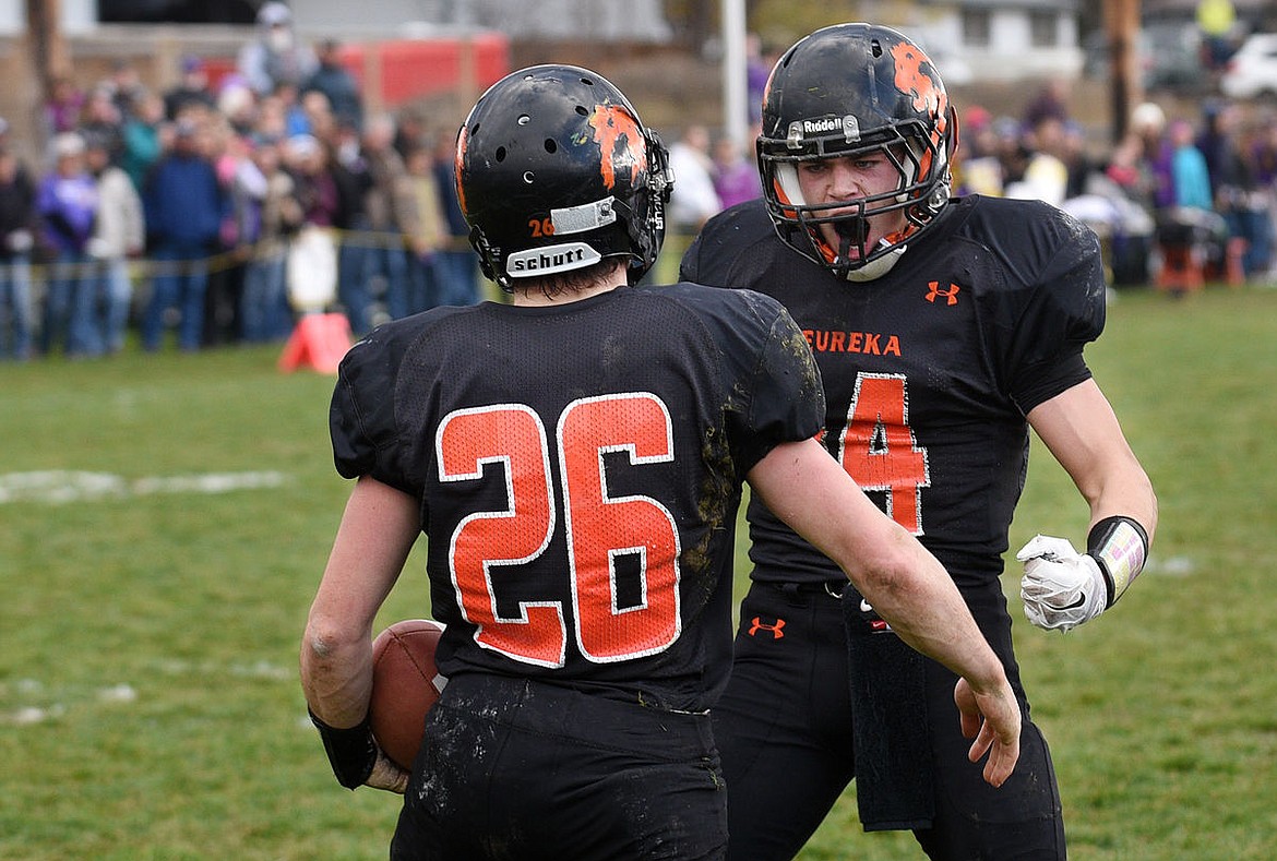 &lt;p&gt;Eureka's Cannan Smith (26) and Austyn Sherwood (14) celebrate after Smith scored his first of five touchdowns in the Lions' 36-7 win against the Whitehall Trojans in the Class B Semifinals at Eureka on Saturday. (Aaric Bryan/Daily Inter Lake)&lt;/p&gt;