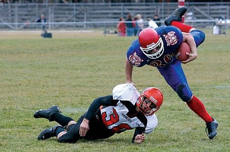 Nick Ianniello/Mineral Independent Superior Bobcat Drew Walen pushes over Absarokee Husky Jeff Royce during the Bobcats&#146; 62-12 playoff victory Saturday afternoon.