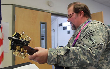 &lt;p&gt;Glacier View music teacher and Army veteran C.J. Mocabee plays the guitar while leading five of his students in patriotic songs.&lt;/p&gt;