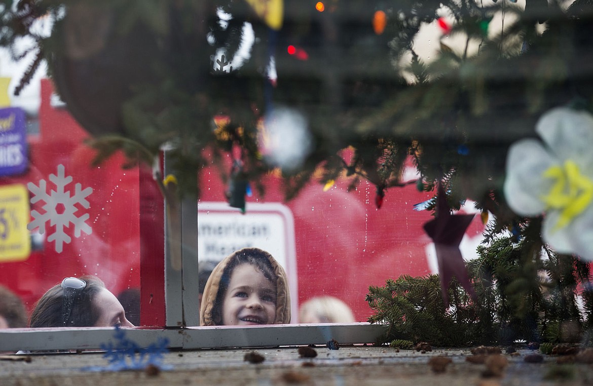 &lt;p&gt;Cally Davidson holds her 6-year-old son, Jesse, as he looks at the U.S. Capitol Christmas tree Friday morning in downtown Coeur d&#146;Alene.&lt;/p&gt;