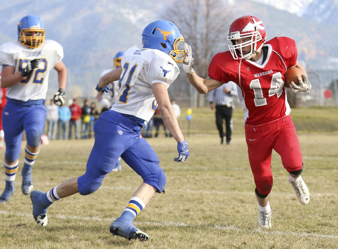 &lt;p&gt;Phil Malatare stiff-arms a Wibaux defender as he tries to get yardage.&lt;/p&gt;