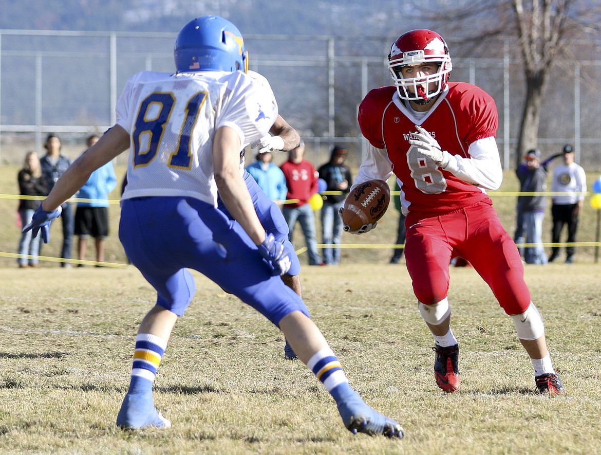 &lt;p&gt;Arlee's Tyler Tanner runs the ball during the the Warriors' playoff game against Wibaux on Saturday.&lt;/p&gt;