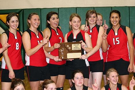 Jamie Doran/Valley Press Matea DePoe, Whitney Wood and Abi Retallick along with the rest of the Lady Savage Heat hold up their District 10-C Championship plaque Saturday evening after beating Charlo 3-2 in the championship game.