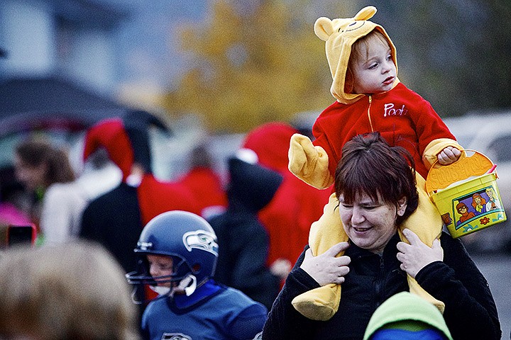 &lt;p&gt;JEROME A. POLLOS/Press Georgia Bucher, 2, rides on the shoulders of her aunt Karen Williams as she scouts the various candy offerings at the Church of Christ's &quot;Trunk or Treat&quot; event Wednesday in Dalton Gardens. Participants filled their vehicle trunks with treats and decorations to provide children with a Halloween alternative to the traditional trick or treating.&lt;/p&gt;