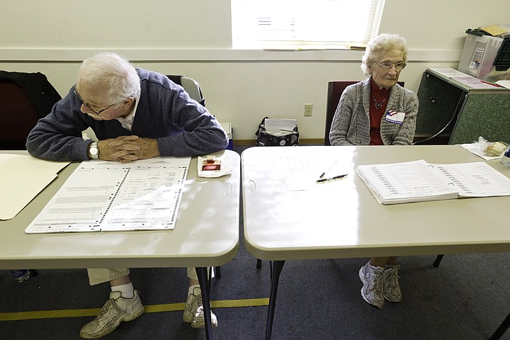 &lt;p&gt;SHAWN GUST/Press Jerry Ford, left, and Joyce Finley waits for voters after a busy morning Tuesday during their volunteer shifts at Emmanuel Baptist Church.&lt;/p&gt;