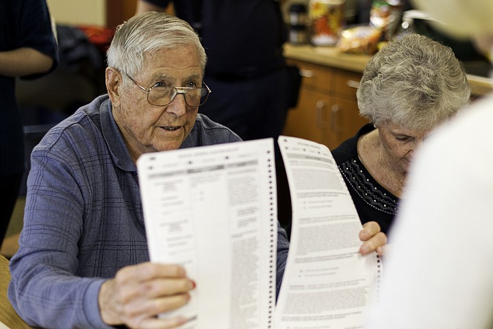 &lt;p&gt;SHAWN GUST/Press Volunteer Joe Smidt explains the two-sided ballot to a voter at a Coeur d'Alene Fire Department.&lt;/p&gt;