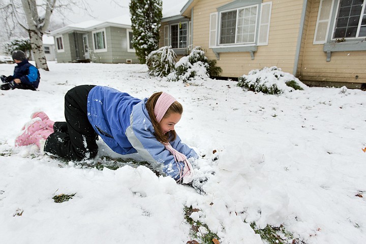 &lt;p&gt;SHAWN GUST/Press Imelda Bresee, 10, pushes snow across the yard while playing in the first snow of the season Friday at her Coeur d'Alene home.&lt;/p&gt;