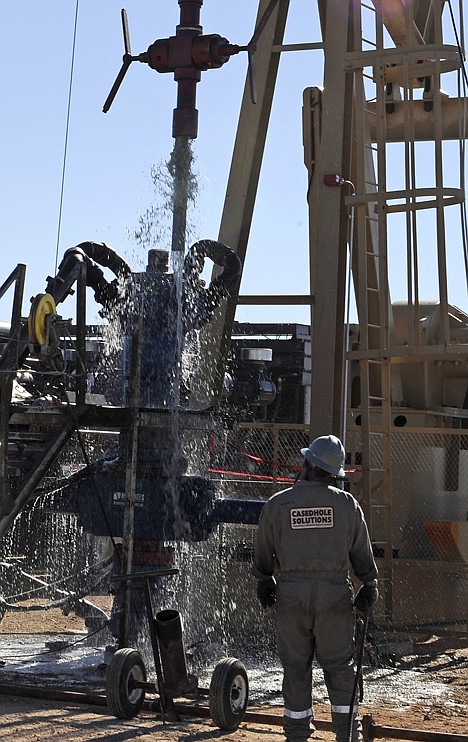 <p>Water gushes out of a drilling pipe as it is pulled up to be replaced with a fresh pipe at a hydraulic fracturing site in Midland, Texas, Sept. 24.</p>