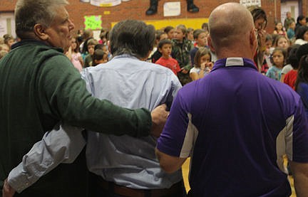 &lt;p&gt;Marvin Bjorge, right, and friend help World War II veteran Orville Bjorge, 91, of Hot Springs, stand while the audience members give the veterans a standing ovation at Linderman Elementary School&#146;s salute to vets Nov. 11. Bjorge was an Army private when he was wounded in Italy. He was transported out of the mountains on a cable tram built by the Corps of Engineers. His ordeal was retold in a book called &#147;The Last Ridge.&#148; Orville is Marvin&#146;s uncle.&lt;/p&gt;&lt;p&gt;&lt;/p&gt;