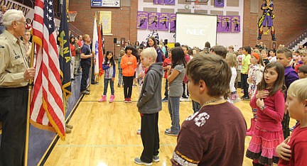 &lt;p&gt;The color guard members stand in a straight line while the students make a pledge.&lt;/p&gt;