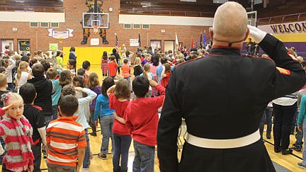 &lt;p&gt;Marine Chuck Lewis and the Linderman students salute the color guard while one little girl (lower left) seems to salute the angular Lewis.&lt;/p&gt;