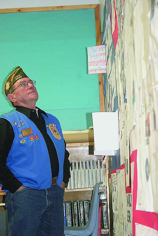 &lt;p&gt;Veteran Joe Eisenbrandt looks over a poster created by seventh and eighth graders thanking veterans for their service.&lt;/p&gt;