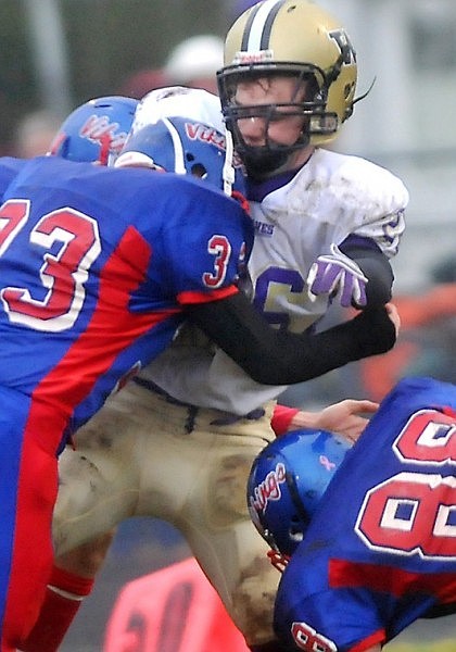 Cut Bank's Scott Broere gets hit hard by Bigfork's Colson McCoard (33).