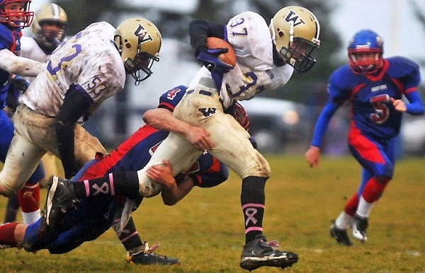 Cut Bank's JJ Lighthizer (37) keeps his legs moving as he tries to escape a tackle from Bigfork's Travis Knoll.