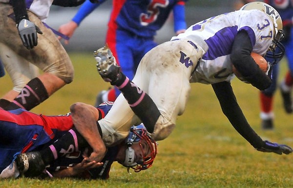 Bigfork's Travis Knoll keeps his eyes on the ball as he brings down Cut Bank's JJ Lighthizer (37).