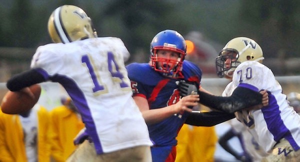 Bigfork's Connor Coleman gets around Cut Bank's Jeremy Moss (70) in pursuit of quarterback Dylan Smith (14).