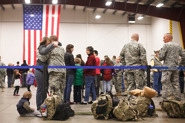 &lt;p&gt;Patrick Cote/Daily Inter Lake With their son Jaxon Calkins, 2, at their feet, Megan Auclair and Specialist Justin Calkins hug Tuesday morning before the deployment of the Montana National Guard's 495th Combat Sustainment Support Battalion from the Glacier Jet Center at Glacier International Airport. Tuesday, Nov. 6, 2012 in Kalispell, Montana.&lt;/p&gt;