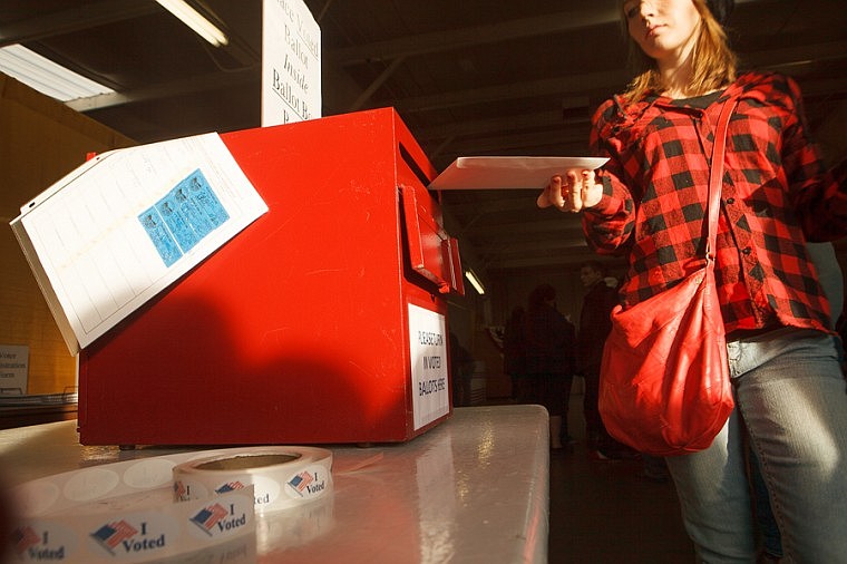 &lt;p&gt;Kate Gunderson drops her ballot in the ballot box Friday afternoon at the Flathead County Fairgrounds in Kalispell. Gunderson said she waited in line for more than three hours to complete her voter registration and cast her first vote.&lt;/p&gt;