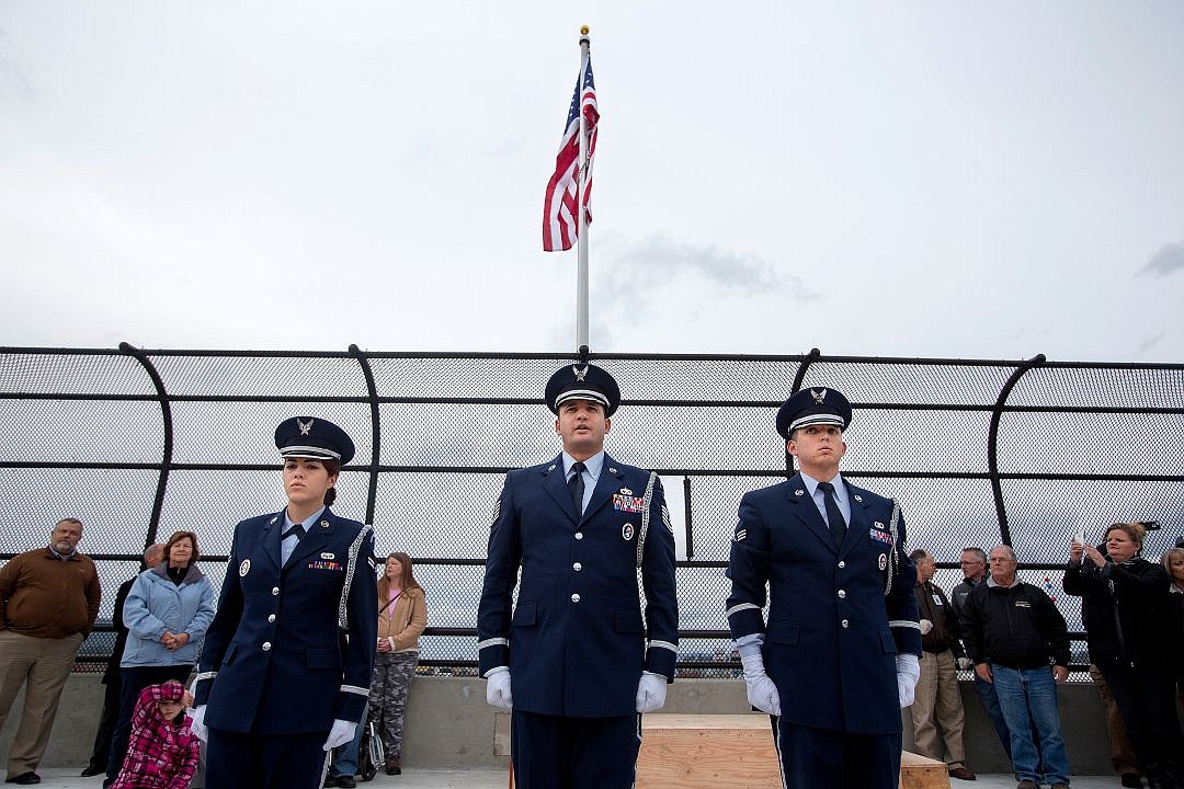 &lt;p&gt;From left to right, A1C Jessica Payne, Tech. Sgt. Carlos Torres and SrA Charles Nichols stand in front of an American flag they raised above the Greensferry Overpass during the dedication of the new bridge on Thursday in Post Falls. Two flags, flown above the nation's and state's capitol buildings, fly in the middle of the overpass in honor of the military and first responders.&lt;/p&gt;