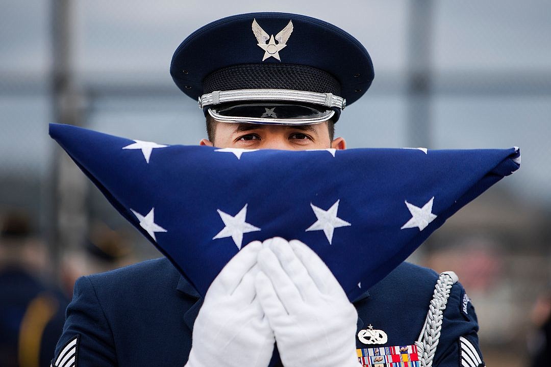 &lt;p&gt;JAKE PARRISH/Press Technical Sgt. Carlos Torres holds a folded American flag that was flown over the nation's and state's capitol buildings before raising the flag above the Greensferry Overpass for the first time during the overpass' dedication on Thursday in Post Falls.&lt;/p&gt;