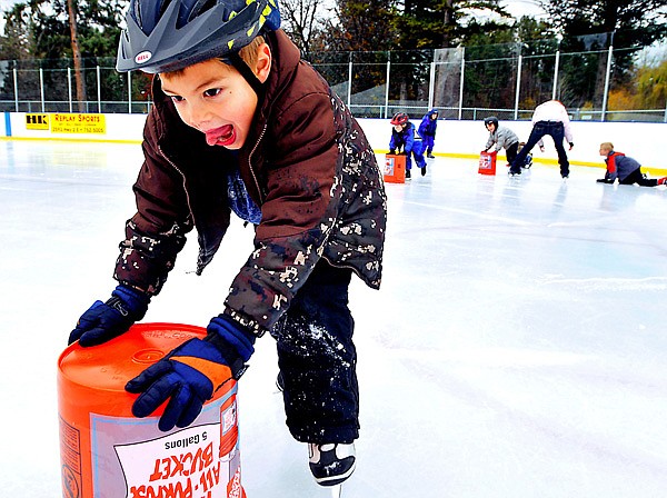 Woodland Montessori kindergartener Mason Molter glides across the ice with the help of a bucket on Monday at the Woodland Ice Center. The class is taking one class a week for the next six weeks as part of its physical education program.