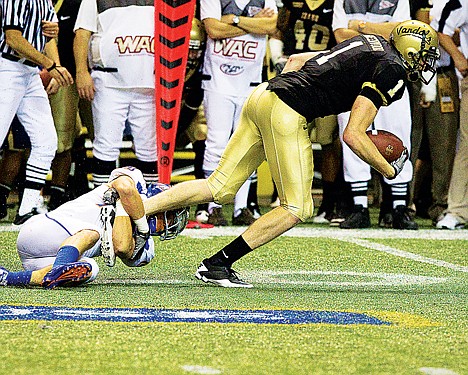 &lt;p&gt;Eric Greenwood, wide receiver for the University of Idaho, can't escape the grasp of Boise State University's Josh Borgman, yet manages to get enough yardage for a first down during the fourth quarter Friday at the Kibbie Dome.&lt;/p&gt;