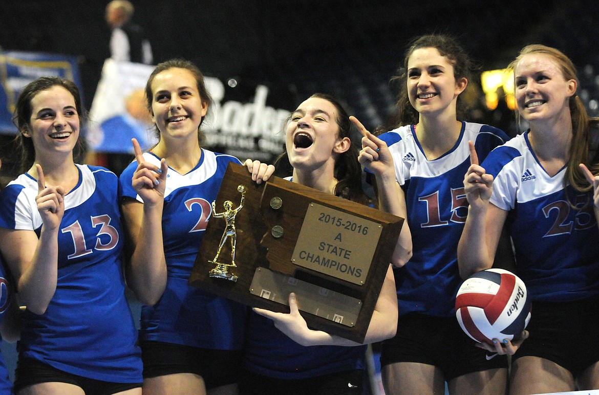 &lt;p&gt;Columbia Falls' Samantha Collins holds the Class A trophy as the Wildkats celebrate their state volleyball championship. (Aaric Bryan/Daily Inter Lake)&lt;/p&gt;