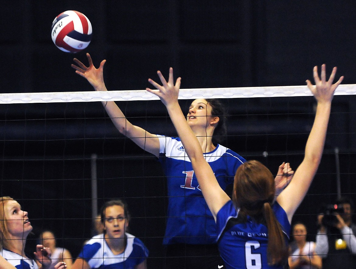 &lt;p&gt;Columbia Falls' Morgan Stenger tips the ball past Corvallis' Genesis Kieth during the Class A state volleyball championship match in Bozeman on Saturday. (Aaric Bryan/Daily Inter Lake)&lt;/p&gt;