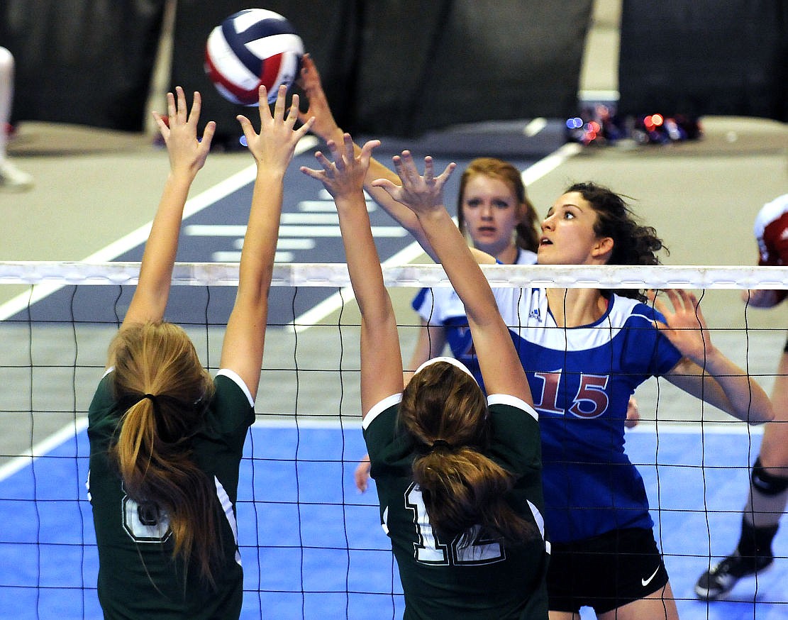 &lt;p&gt;Columbia Falls' Morgan Stenger tips the ball past a pair of Billings Central defenders in the Wildkats 4-set win to open the Montana state championship in Bozeman on Thursday. (Aaric Bryan/Daily Inter Lake)&lt;/p&gt;
