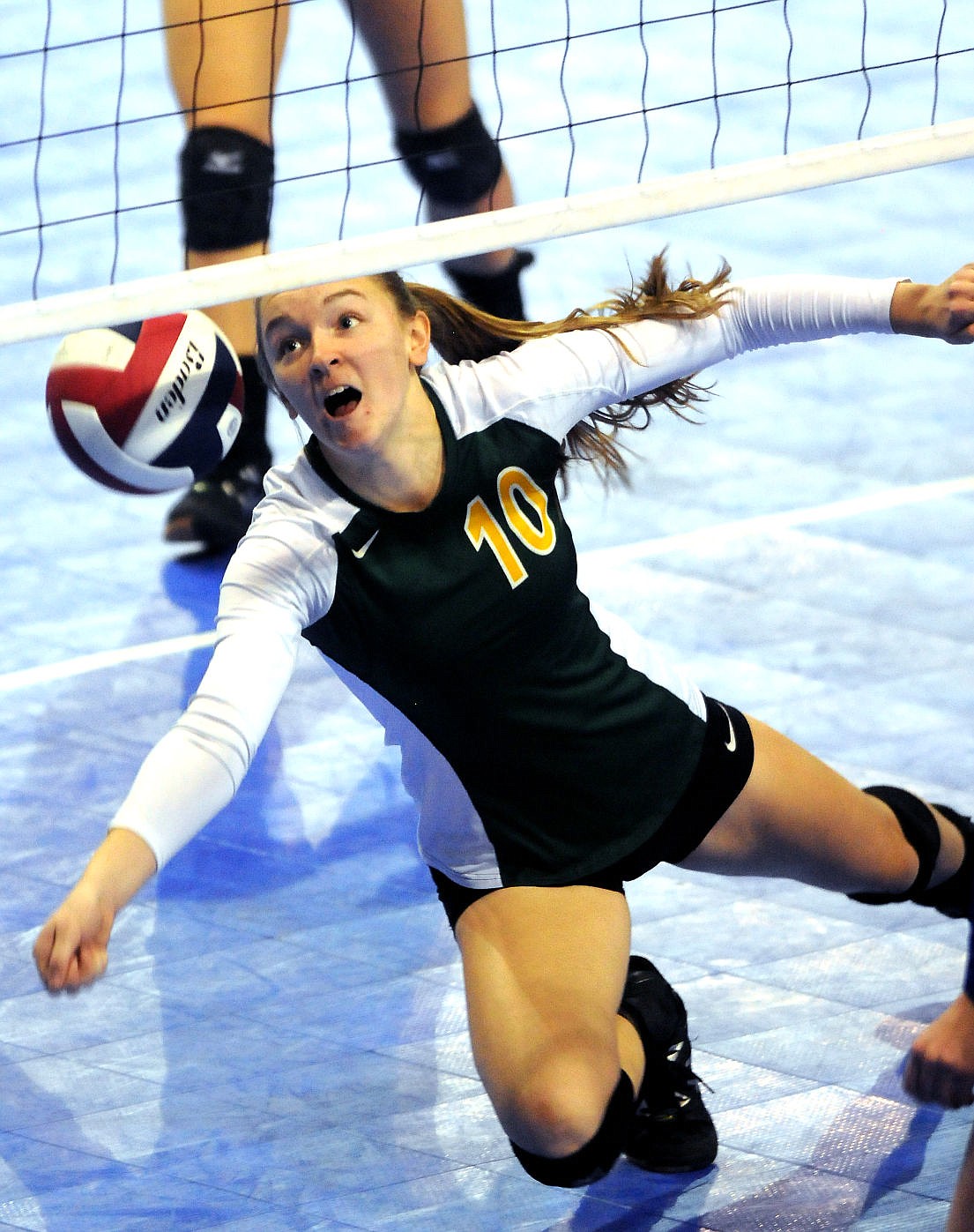 <p>Whitefish's Allie Schulz dives to dig out a ball at the net during the Bulldogs' comeback win against Havre at the state tournament in Bozeman on Friday. (Aaric Bryan/Daily Inter Lake)</p>