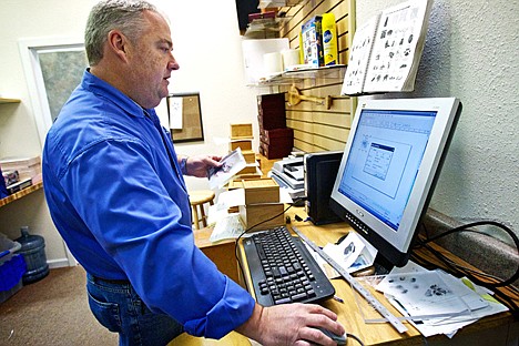 &lt;p&gt;John Gribbin, owner of All Pets Cremation Services, prepares a customers photo for laser etching onto a tile for an urn Friday at his Post Falls business.&lt;/p&gt;