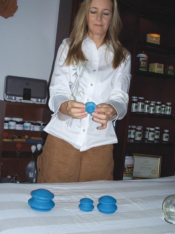 Lynne Lynch/Columbia Basin HeraldLicensed massage practitioner Wendy Nickell show different sizes of suction cups she uses for massage.