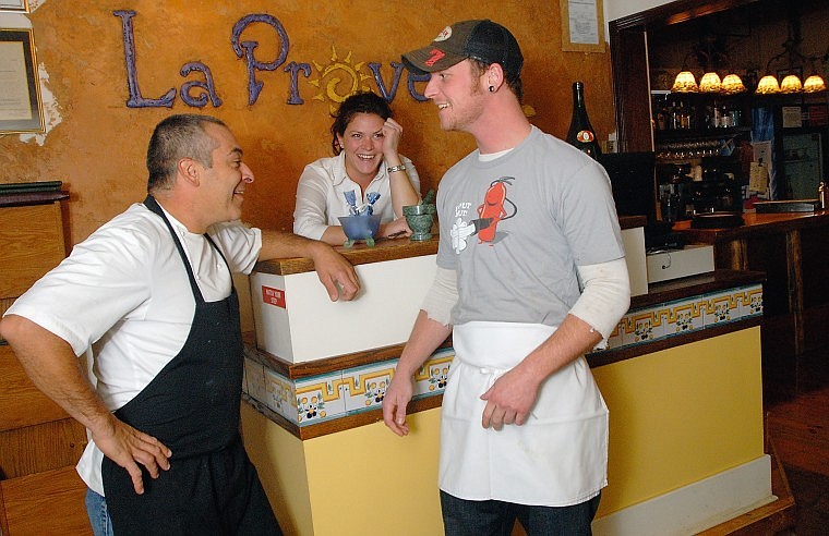 CO-OWNER OF Bigfork&#146;s La Provence Marc Guizol, left, chats with Garden Bar bartender Fletcher Anderson while server Beth Ellison listens in. Anderson ran into the restaurant&#146;s kitchen to put out a fire Tuesday evening, saving the family establishment. &#147;I didn&#146;t really think about it &#151; it was instinct,&#148; Anderson said.