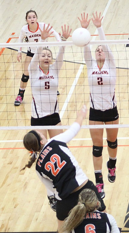 &lt;p&gt;Above right: McKenzie Cates, left, and McKenzie Dulmes make make a team block against Plains.&lt;/p&gt;