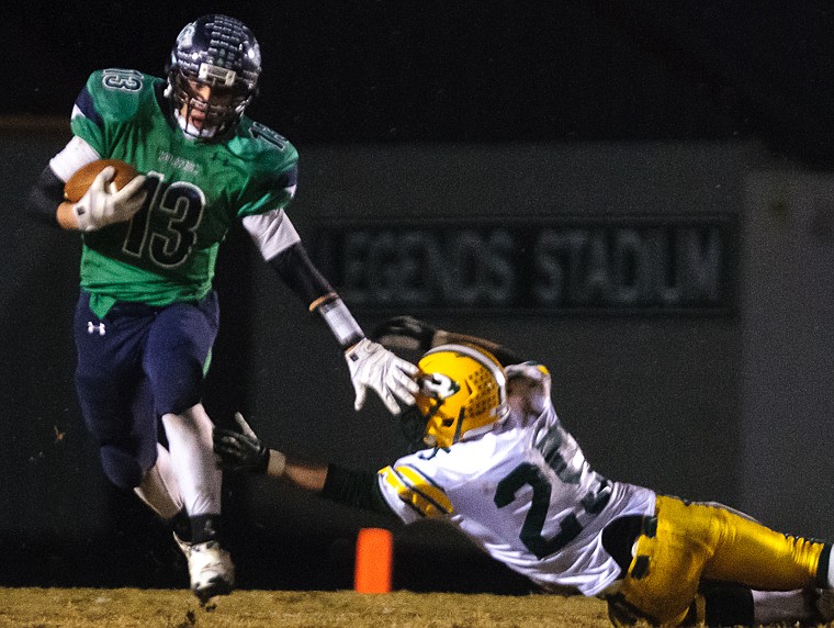 &lt;p&gt;Glacier running back Todd Ogden (13) stiff arms his way to a 96-yard run Friday night against C.M. Russell at Legends Stadium. (Patrick Cote/Daily Inter Lake)&lt;/p&gt;