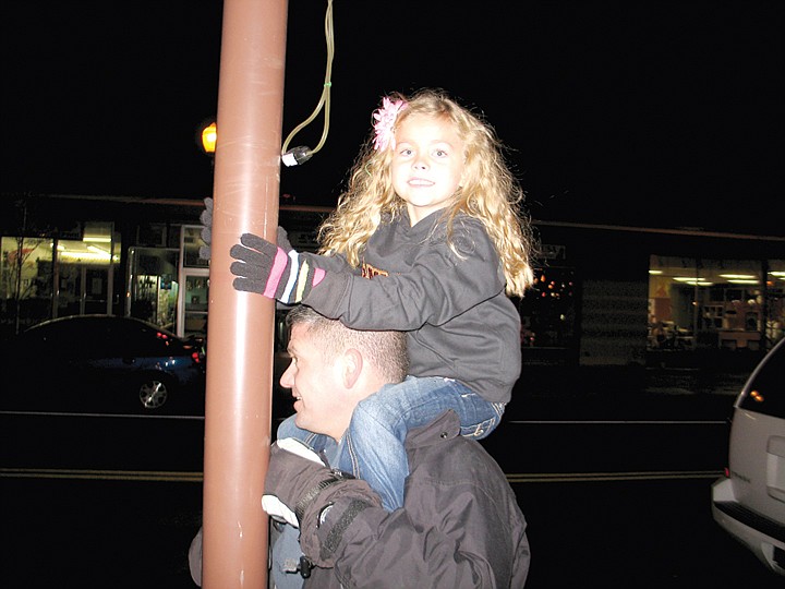 Addy Carlisle prepares to turn on lights at the Moses Lake
Holiday Street Tree Lighting.