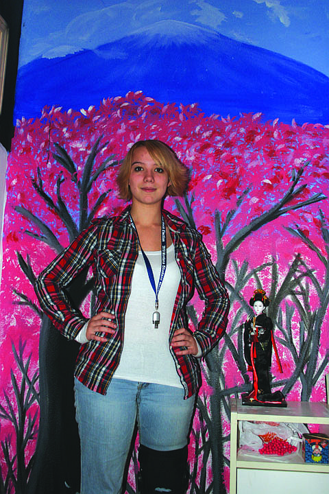 Japenese art has inspired Tiphanie Eriksson as she creates her own pieces. Here, she stands in front of one of the walls she painted. Eriksson hopes to study in  Japan next fall and would like to attend college there.