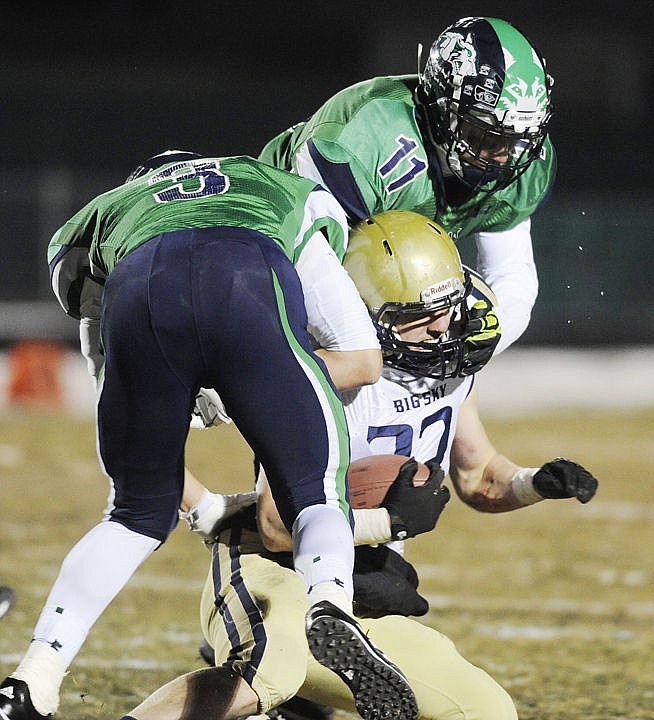 &lt;p&gt;Glacier's Tadan Gilman (3) and Tucker Rauthe (11) sandwich Big Sky's Cory Diaz during the Wolfpack's blowout of the Eagles in the State AA semifinals in Kalispell Friday. (Aaric Bryan/Daily Inter Lake)&lt;/p&gt;