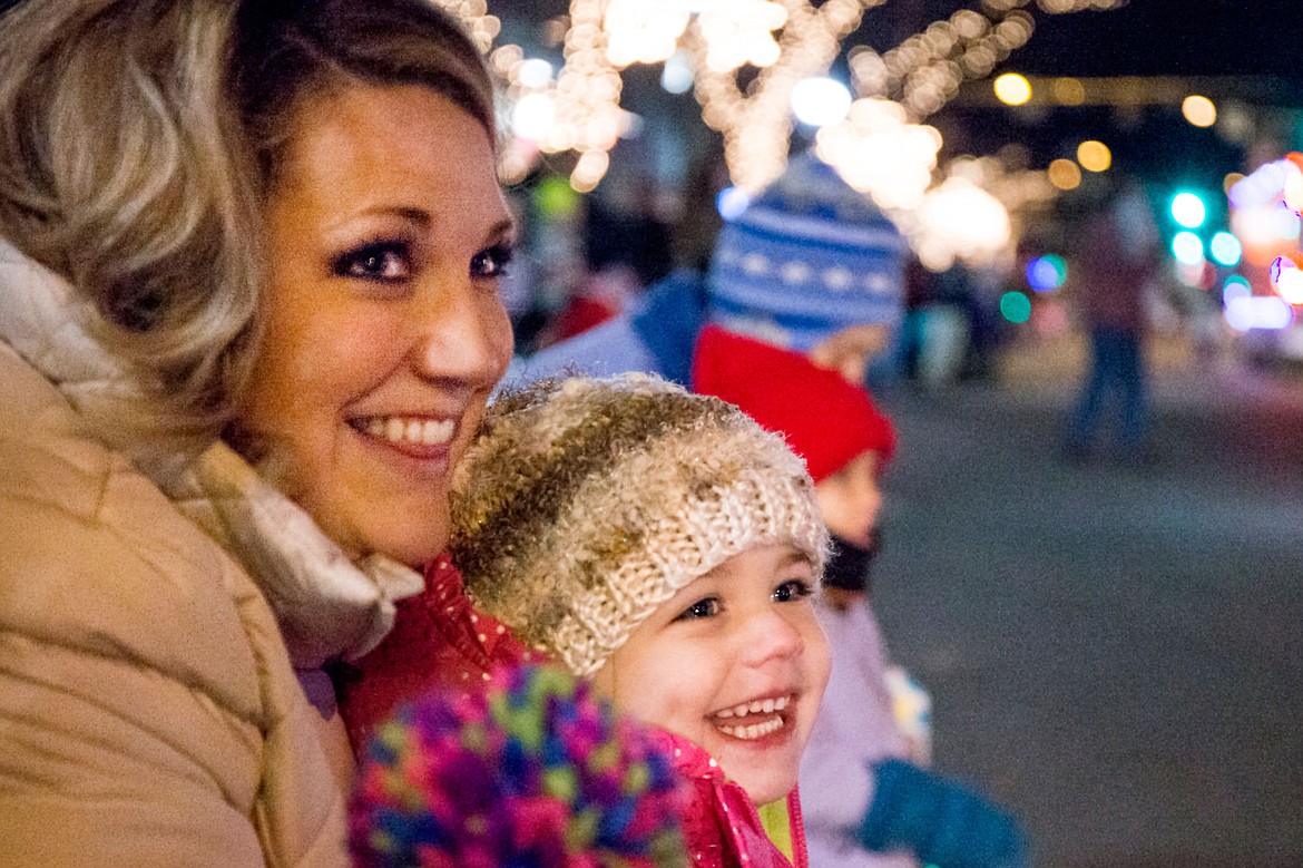 &lt;p&gt;Halle Hatfield, 3, and her mother Drue smile as they watch the holiday &quot;Cool Yule&quot; parade floats move down Sherman Avenue on Friday, Nov. 27, 2015 in Coeur d'Alene before the Coeur d'Alene Resort Holiday Light Show.&lt;/p&gt;