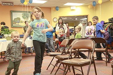 &lt;p&gt;Raisto Cannon gets help from big sister Cali Cannon during musical chairs at North Lake County Library's centennial celebration.&lt;/p&gt;