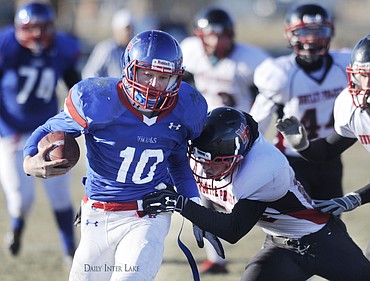 <p>Bigfork quarterback Josh Sandry is driven out of bounds during a long run to start the third quarter against Huntley Project at Bigfork on Saturday. (Aaric Bryan/Daily Inter Lake)</p>