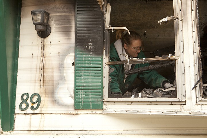 &lt;p&gt;Crystal Atchinson sorts through the remains of her brother's
trailer that burned down in the Forest Acres Mobile Home Park early
Monday morning.&lt;/p&gt;