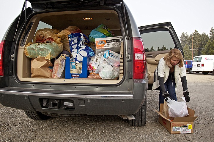 &lt;p&gt;JEROME A. POLLOS/Press Pam Downs, a food bank volunteer, organizes food Wednesday that she'll deliver to organizations that have clients who are not able to travel to the Community Action Partnership food bank. Downs relies on donations that she collects for the food bank in order to make the deliveries.&lt;/p&gt;