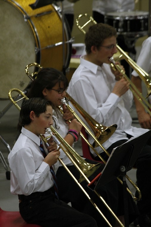 Ty Cummings, Keira Gill and Josh Eitelberg play trombone during a combined piece with the middle and high school bands.