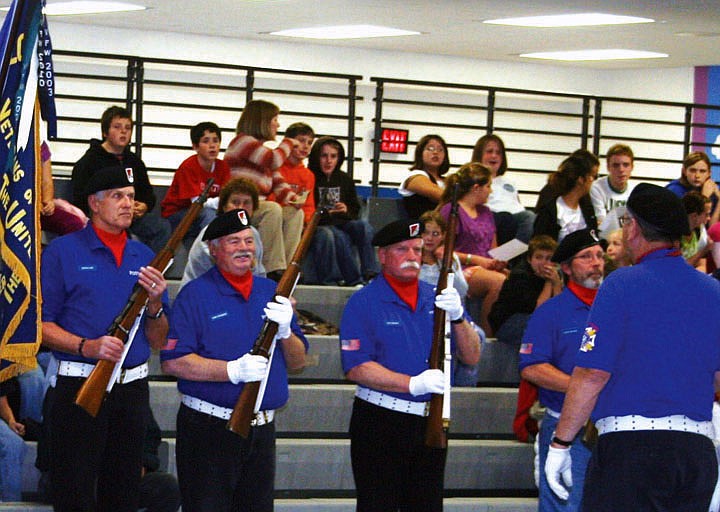 Ed Heppe commands the men from the VFW post to postition the rifles as they carry them. From left to right: Chuck Case, Gary Chambers, Dan Arnsan and Rhandy Kryzsko.