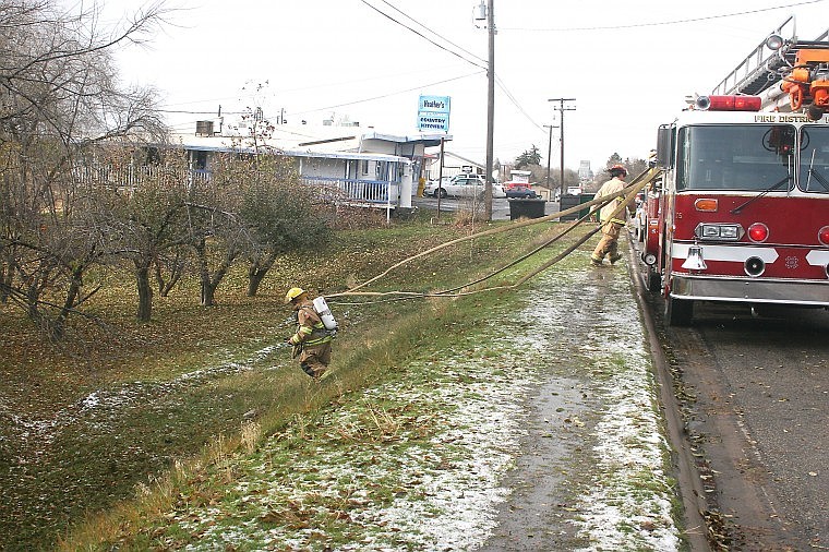 &lt;p&gt;A Plains city fireman runs the hose down the hill to reach the
basement of the residence in which the fire was burning.&#160;&lt;/p&gt;