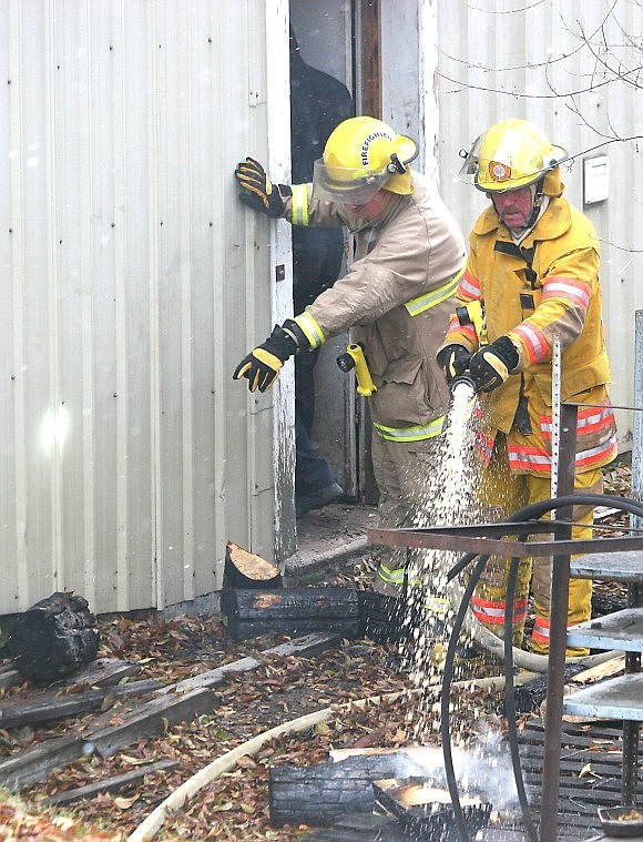 &lt;p&gt;Plains firemen hose down firewood from the basement fire.&#160;&lt;/p&gt;