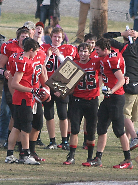 &lt;p&gt;Savage Heat seniors Mike Gray (center), Wyatt Nagy (left) and Dave Cross (right) hold the state champions trophy Saturday, Nov. 17 shortly after their victory over Big Sandy, 77-0, as Queen's &quot;We Are the Champions&quot; plays over the speakers.&lt;/p&gt;