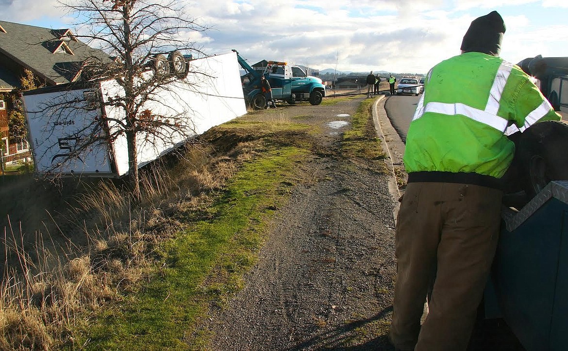 &lt;p&gt;Tony Bryant, an operator with Recovery Masters, works on turning an overturned trailer on its side this morning after Tuesday night's windstorm caused the crash on Seltice Way just east of Idaho Street in Post Falls.&lt;/p&gt;